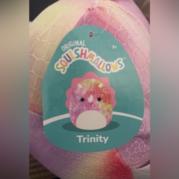 Squishmallow Trinity the Pink Triceratops. Trinity is a tie-dyed dinosaur - Picture 7 of 8